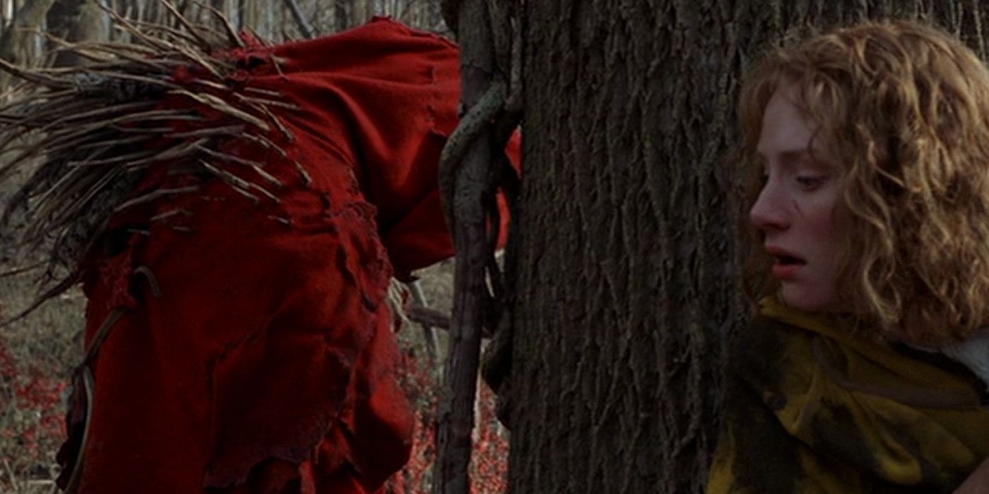 Ivy hides behind a tree from monster in red robe