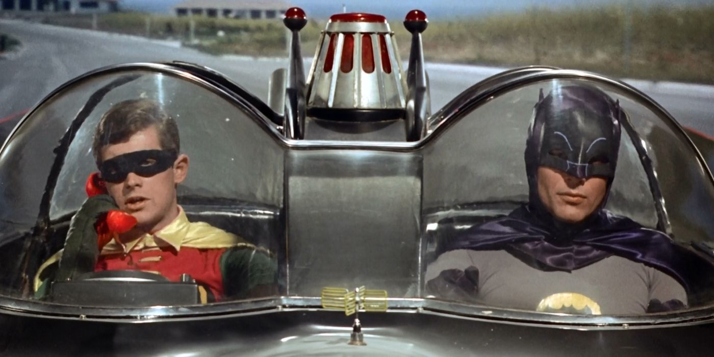 Burt Ward as Robin and Adam West driving in the Batmobile.