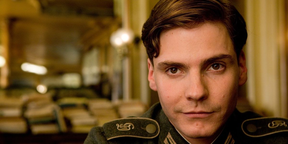 Daniel Bruhl sitting in a cafe in Inglorious Basterds