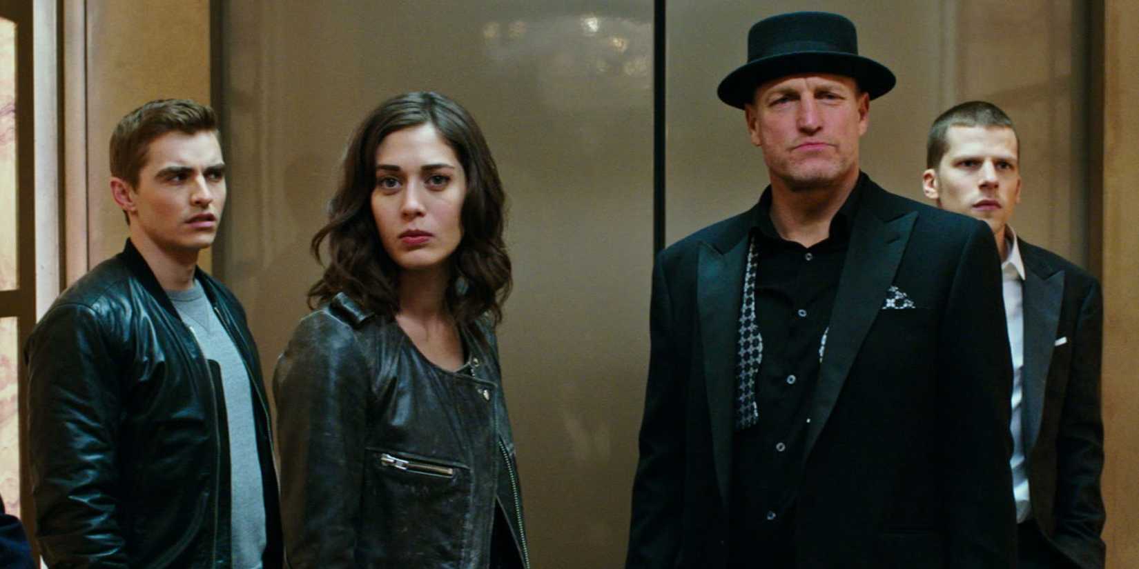 Dave Franco, Lizzy Caplan, Woody Harrelson, and Jesse Eisenberg standing together in Now You See Me 2