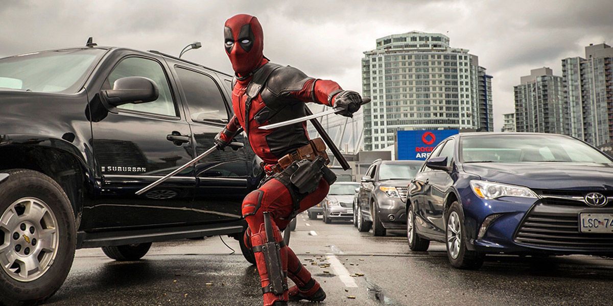 Deadpool with his swords out on the bridge.