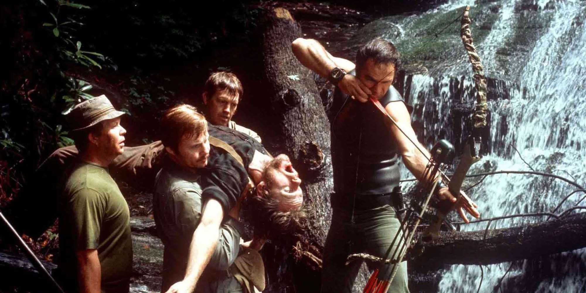 Lewis about to fire his bow while his friends look on in Deliverance