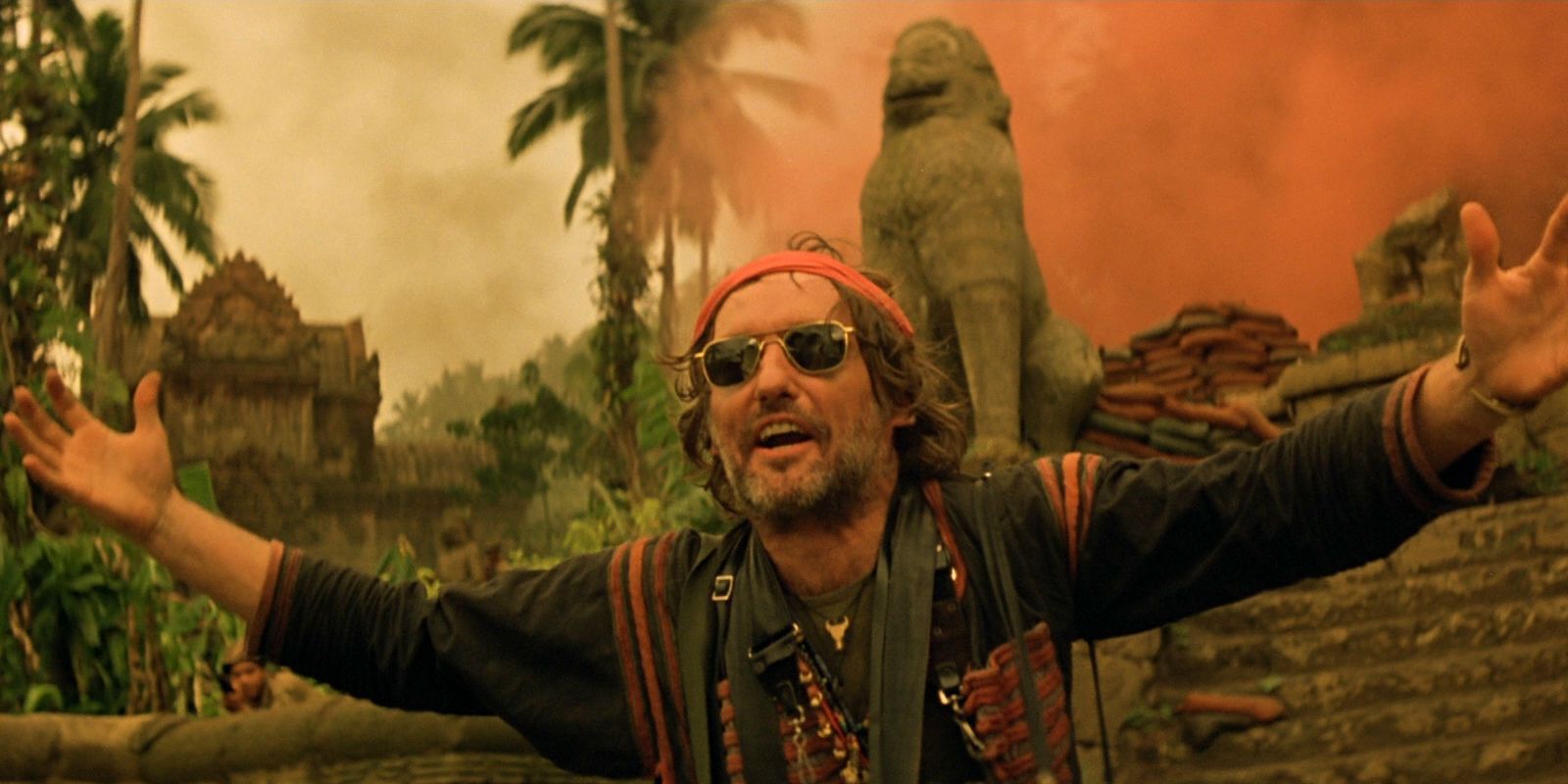 Dennis Hopper in front of a red plume of smoke in Apocalypse Now