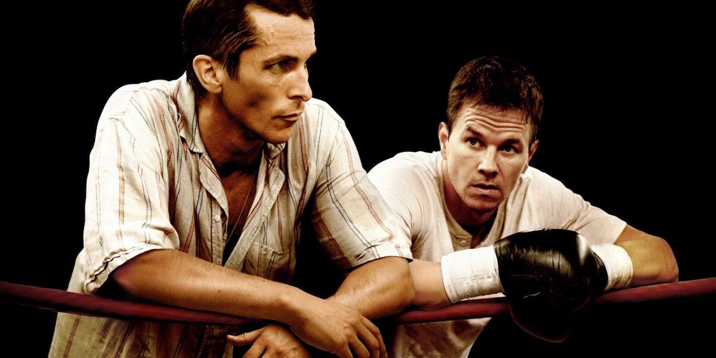 Dicky Ecklund (Christian Bale) and Micky Ward (Mark Wahlberg) leaning against the ropes in a ring in The Fighter