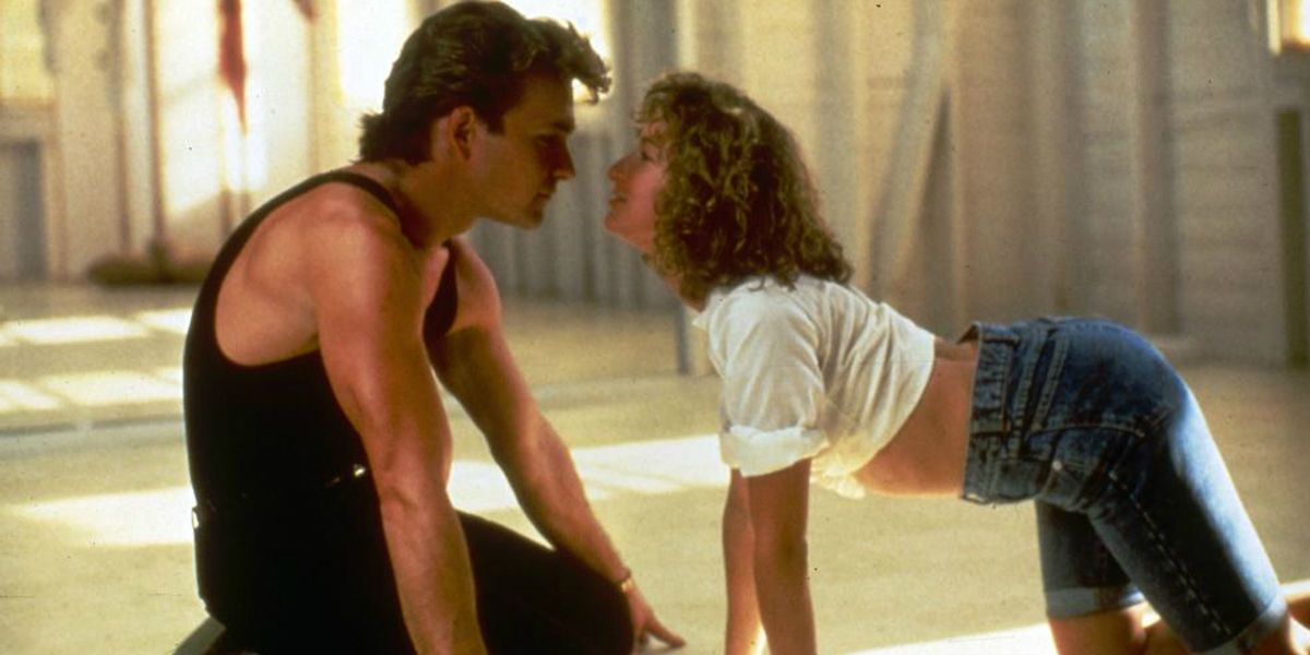 A man and woman look into each other's eyes while on the floor in Dirty Dancing 