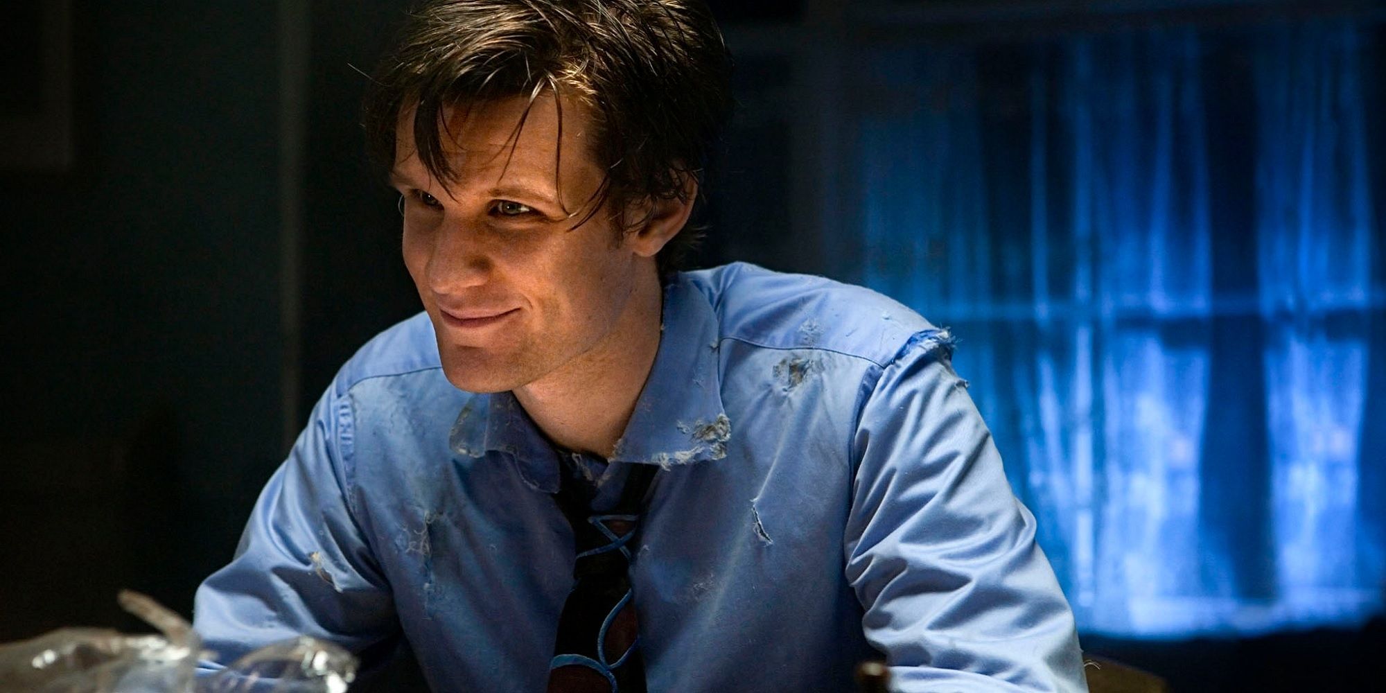 Doctor Who image with Matt Smith's Eleventh Doctor smiling in a dark room