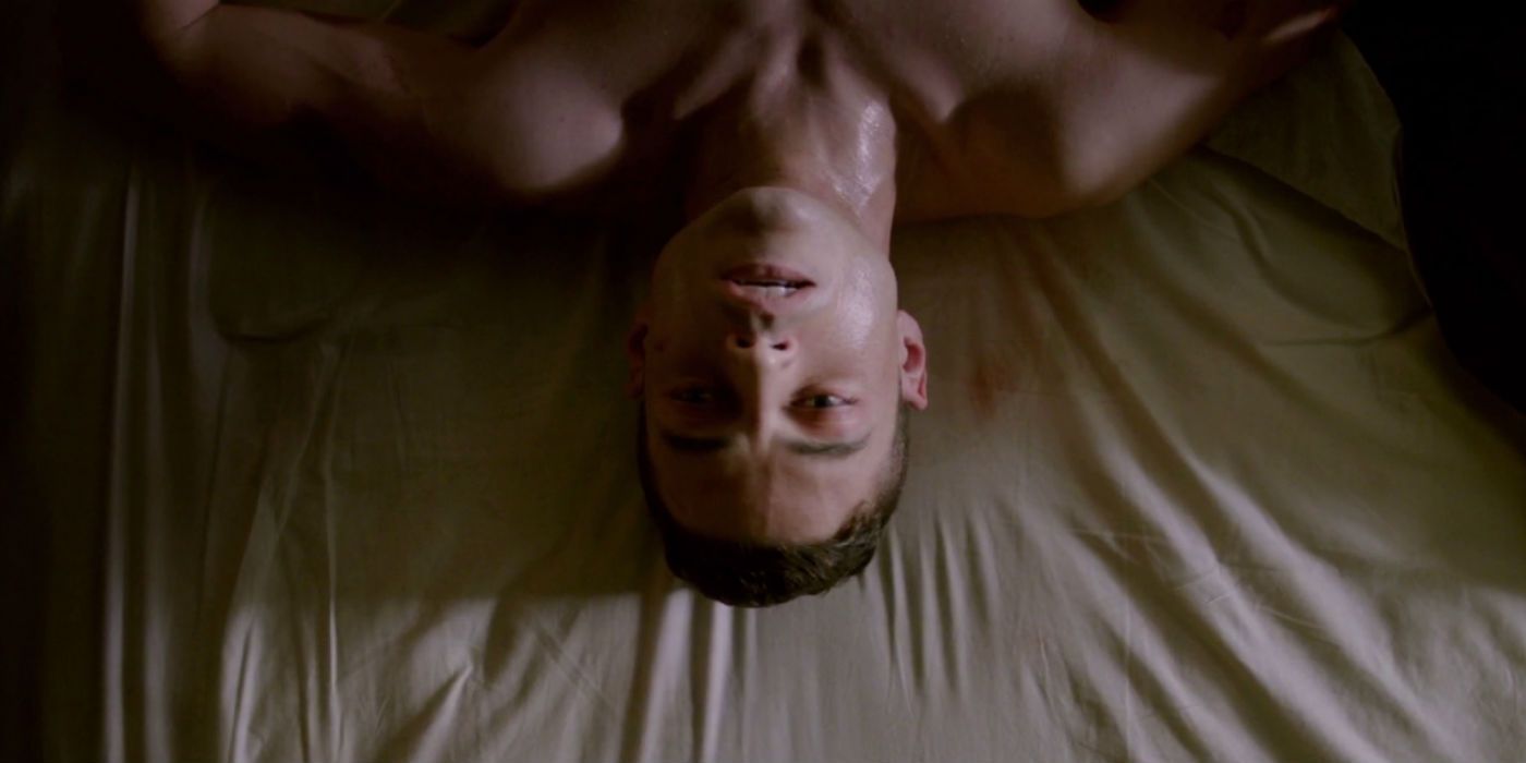 Elliot lying upside down in the bed in a scene from Mr. Robot.