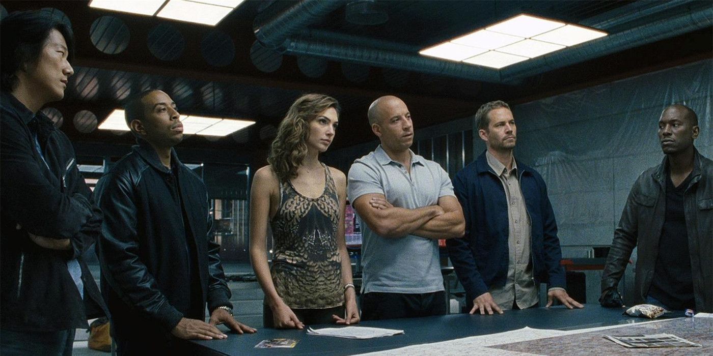 The Fast Family around a table in Fast & Furious.