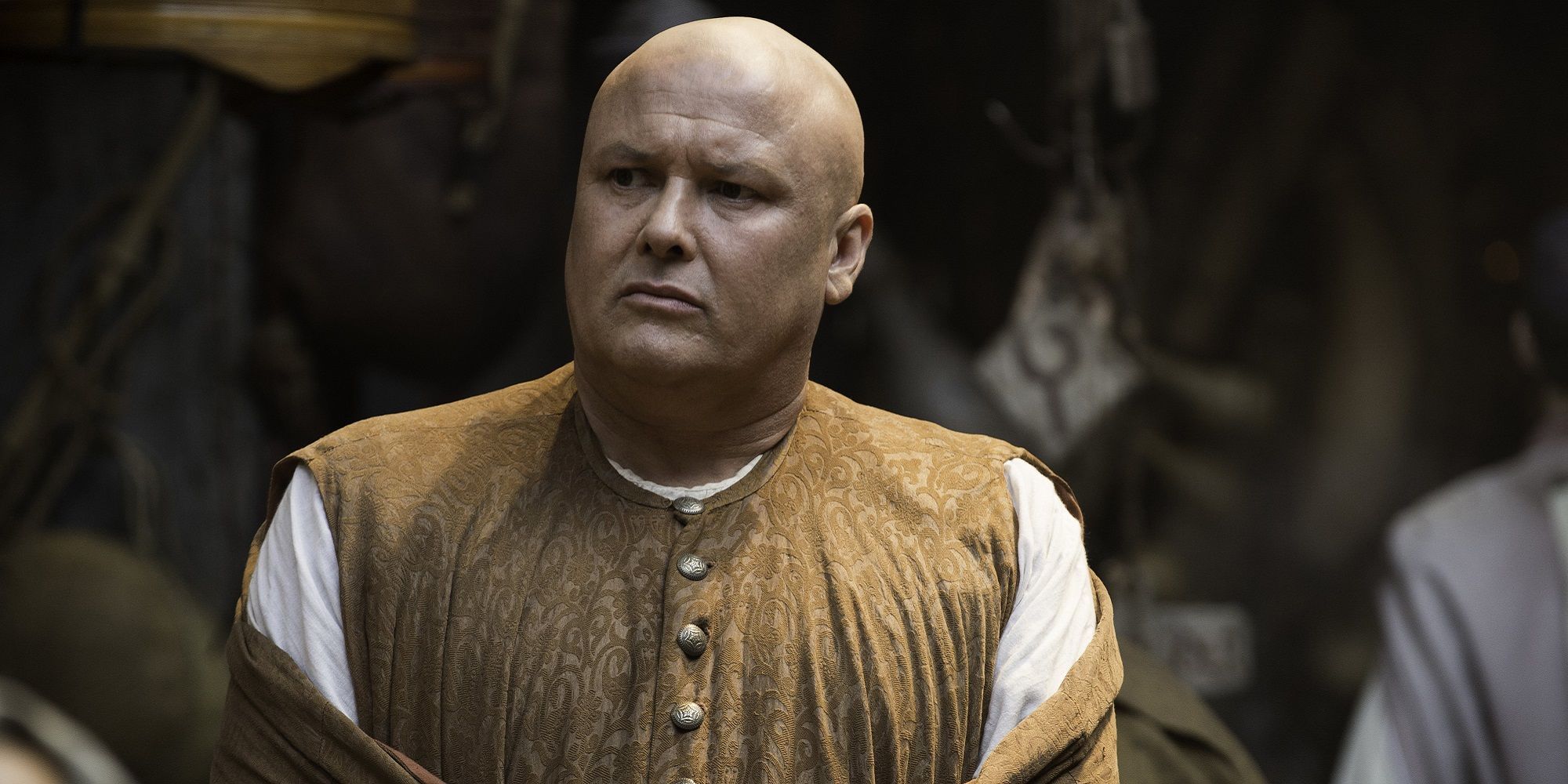 Lord Varys walking among a crowd in Game of Thrones.