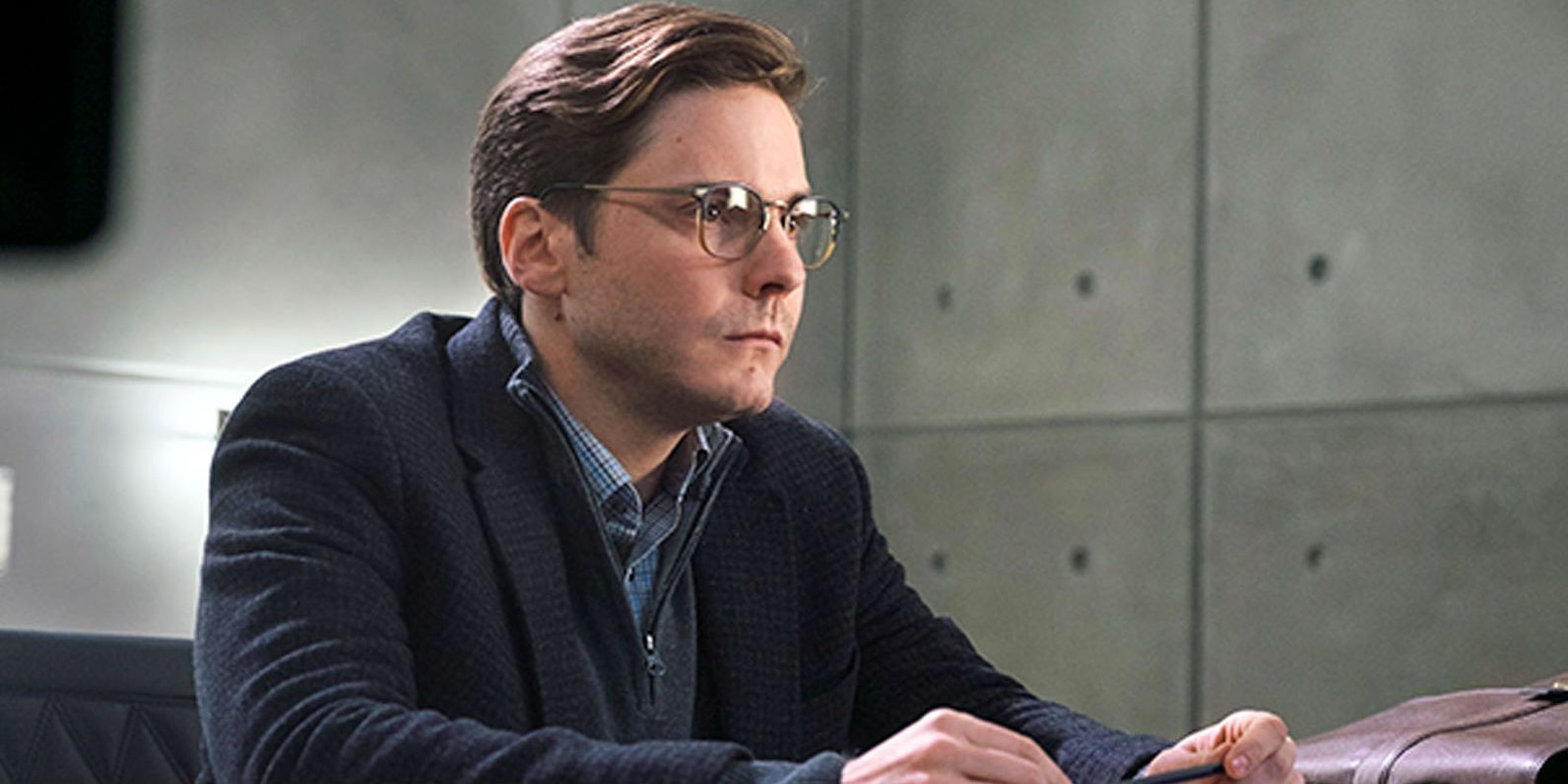 Helmut Zero sitting behind a desk in an empty room in Captain America: Civil War