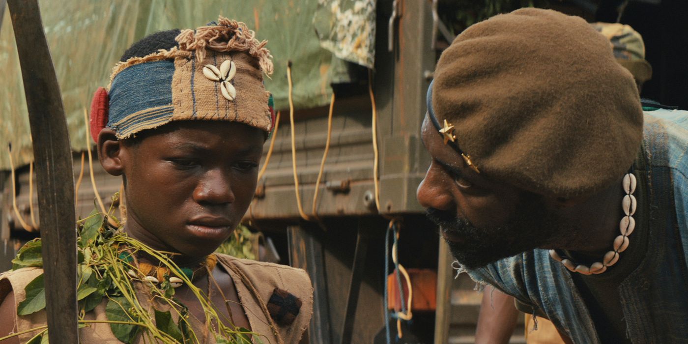 Idris Elba looking at Abraham Attah in Beasts of No Nation