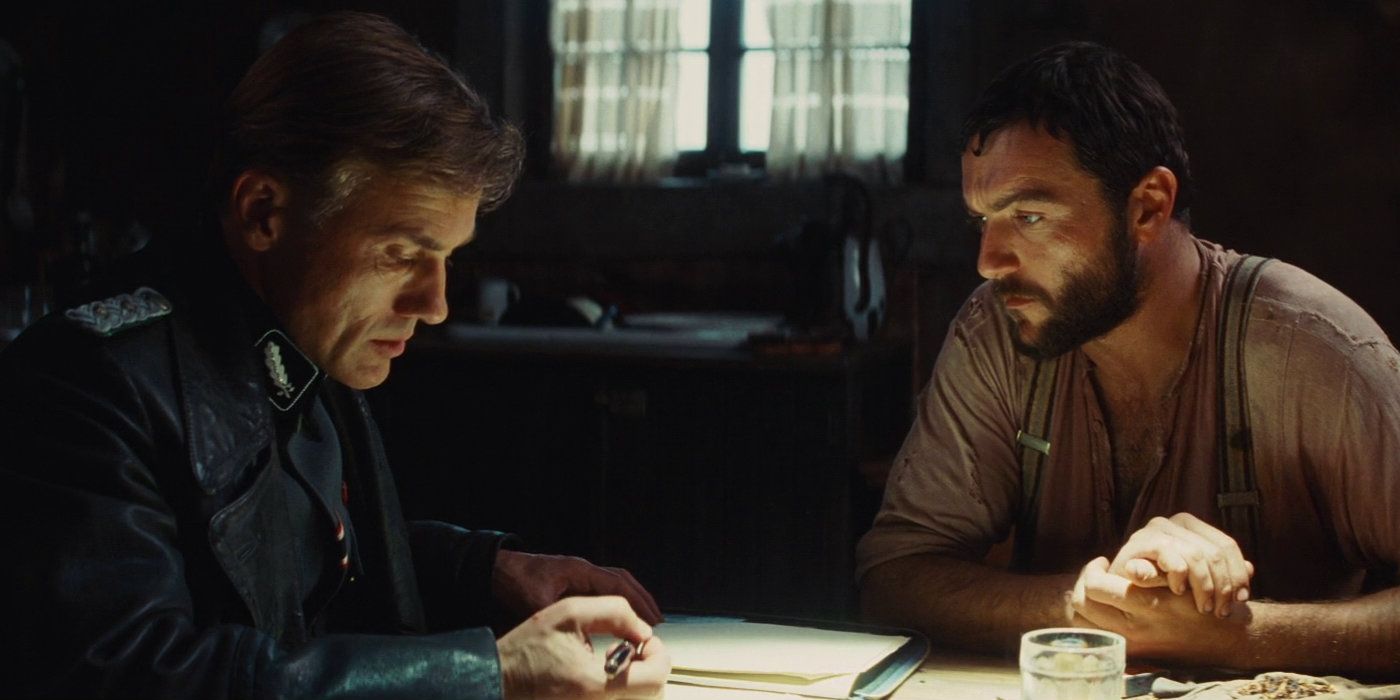 Christoph Waltz and Denis Menochet in farm house during opening of Inglorious Basterds