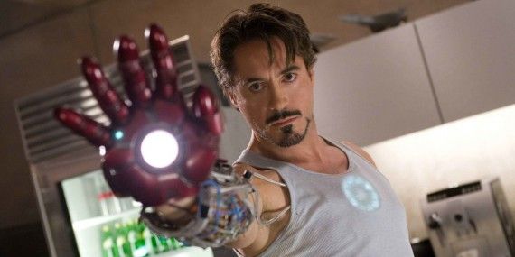 Robert Downey Jr. raising a prototype gauntlet in Iron Man 2008