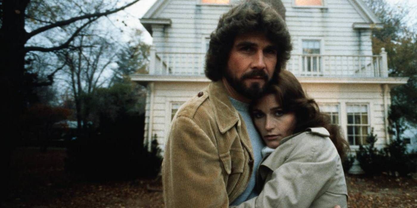 James Brolin and Margot Kidder in The Amityville Horror hugging outside the house