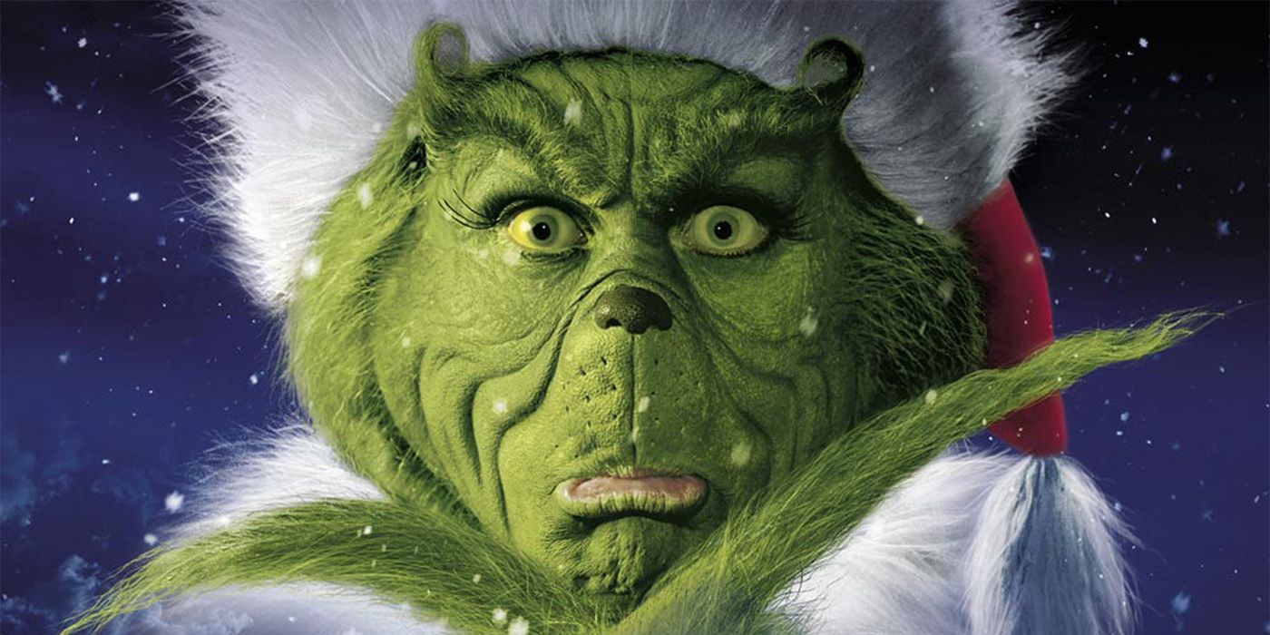 Jim Carrey as the Grinch looking pensive in How the Grinch Stole Christmas