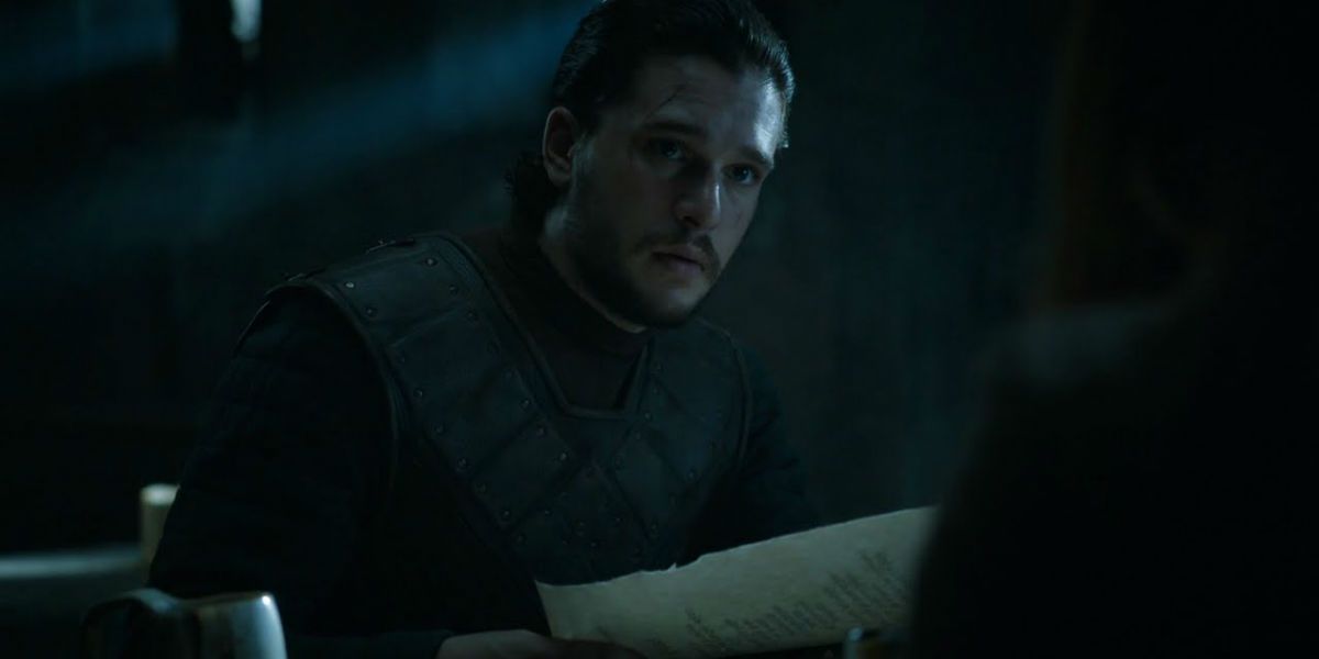 Jon Snow holds a letter looking concerned in Game of Thrones season 6