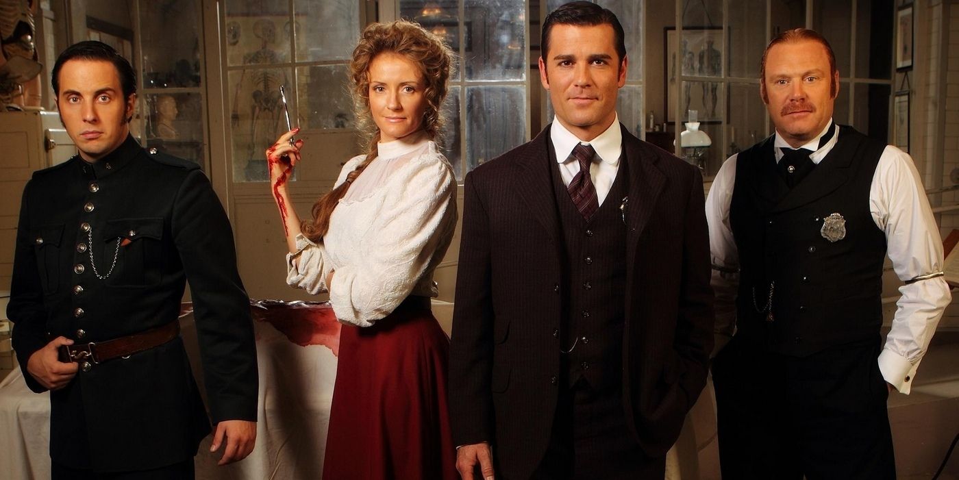 The cast of Murdoch Mysteries pose for a promo shot 