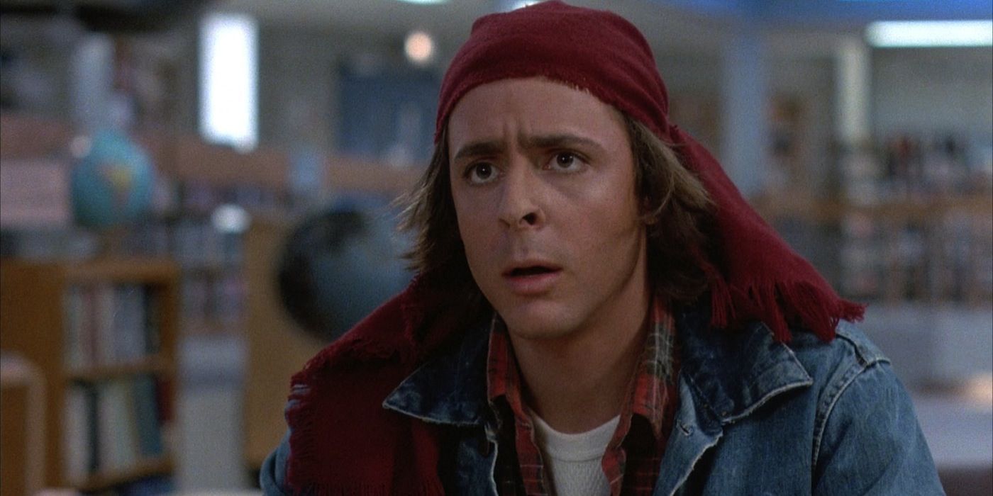 Judd Nelson sits in the library in The Breakfast Club