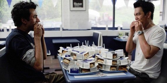 Harold and Kumar sit in front of dozens of burgers in White Castle