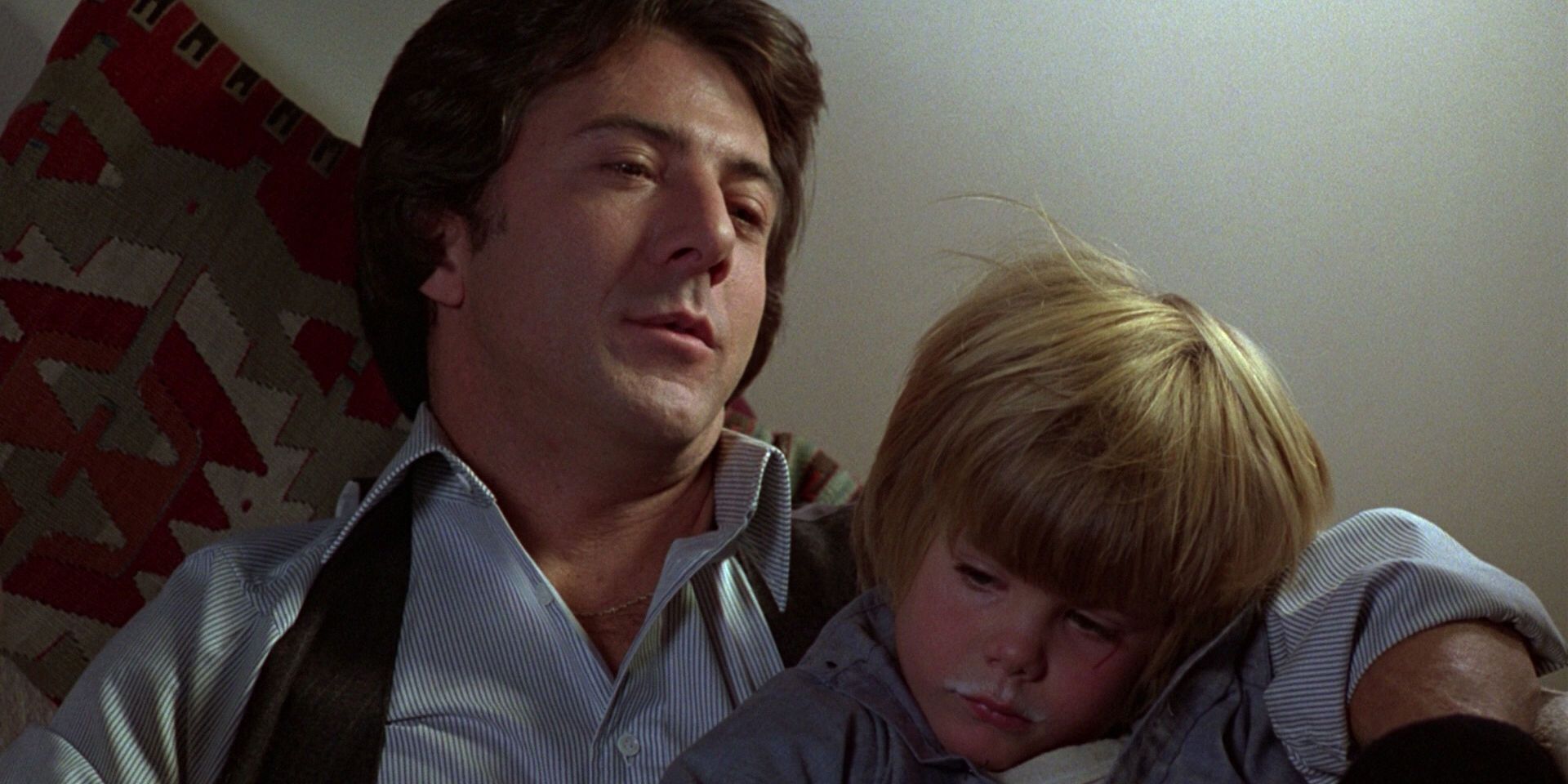 Dustin Hoffman looks tired as he holds his young son in Kramer vs Kramer