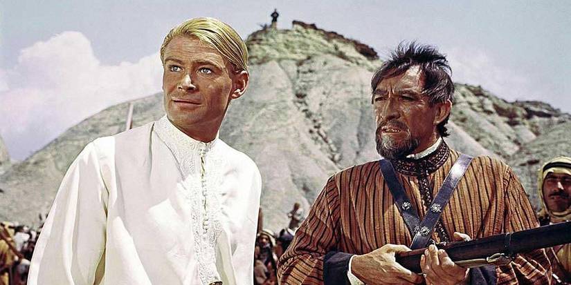 Peter O'Toole as Lawrence and a man with a gun in Lawrence of Arabia