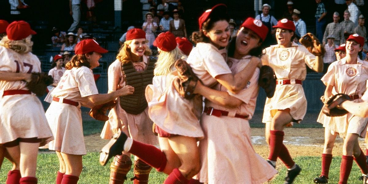 Madonna and Rosie hug on the field in Dottie and Jimmy in the dugout in A League of Their Own