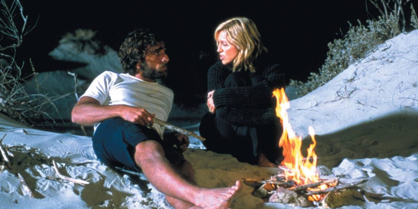 Madonna talking to Adriano Gianni on the beach at night in Swept Away