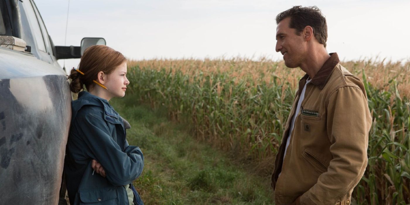 Makenzie Foy and Matthe McConaughey talk by a corn field in Interstellar