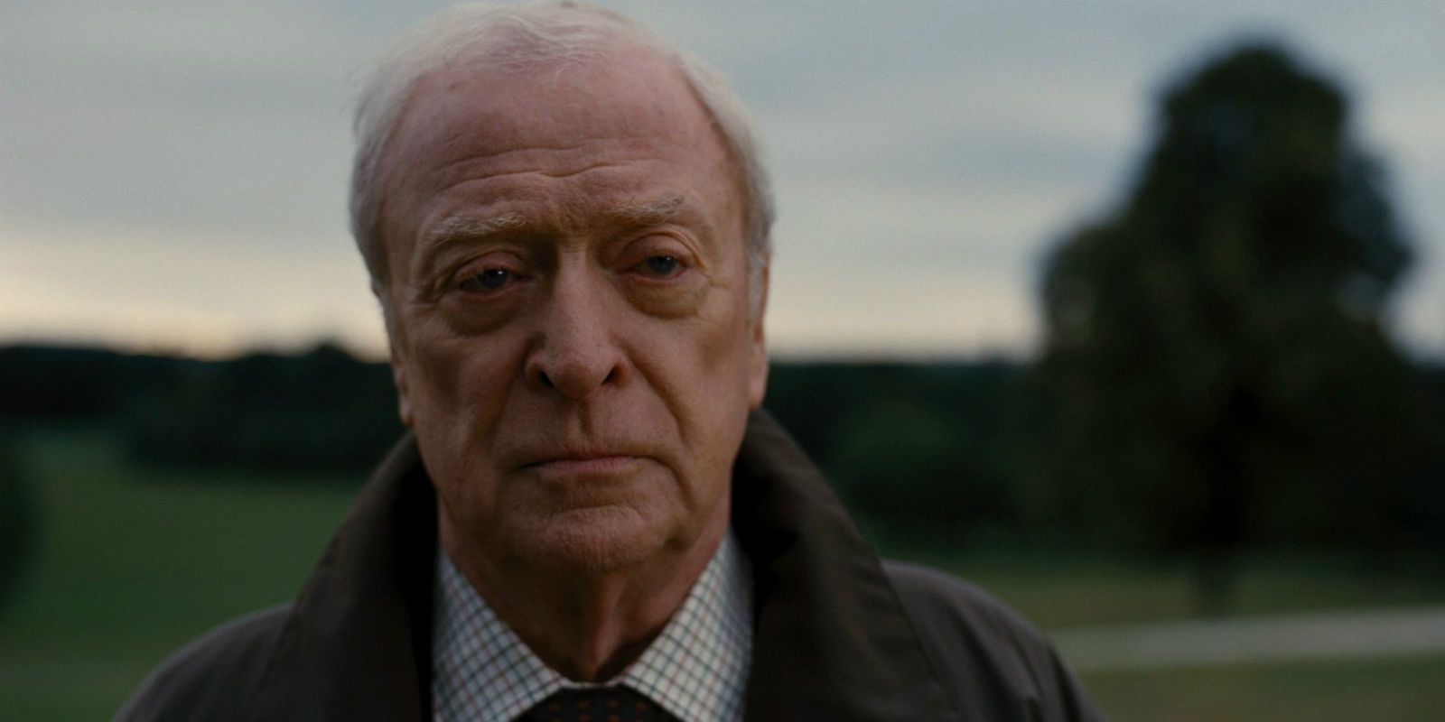 Alfred looking upset in The Dark Knight Rises