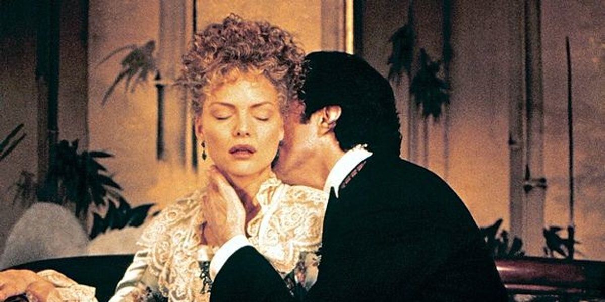 A man kisses Michelle Pfeiffer's neck in The Age of Innocence 