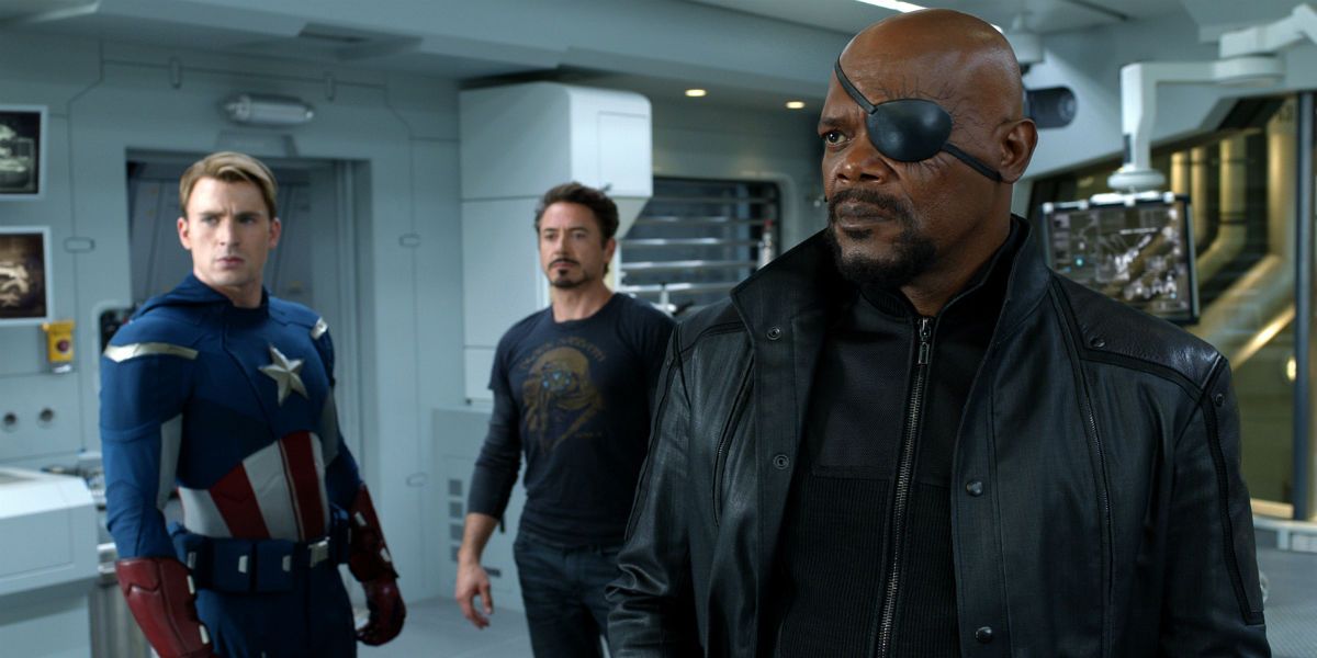 Nick Fury stands next to Captain America and Iron Man.