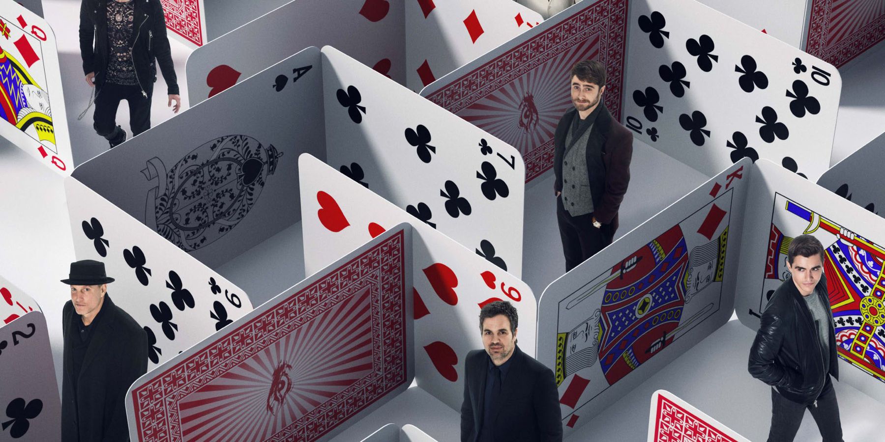 The characters of Now You See Me 2 wander through a maze of playing cards in a promo image for the film.