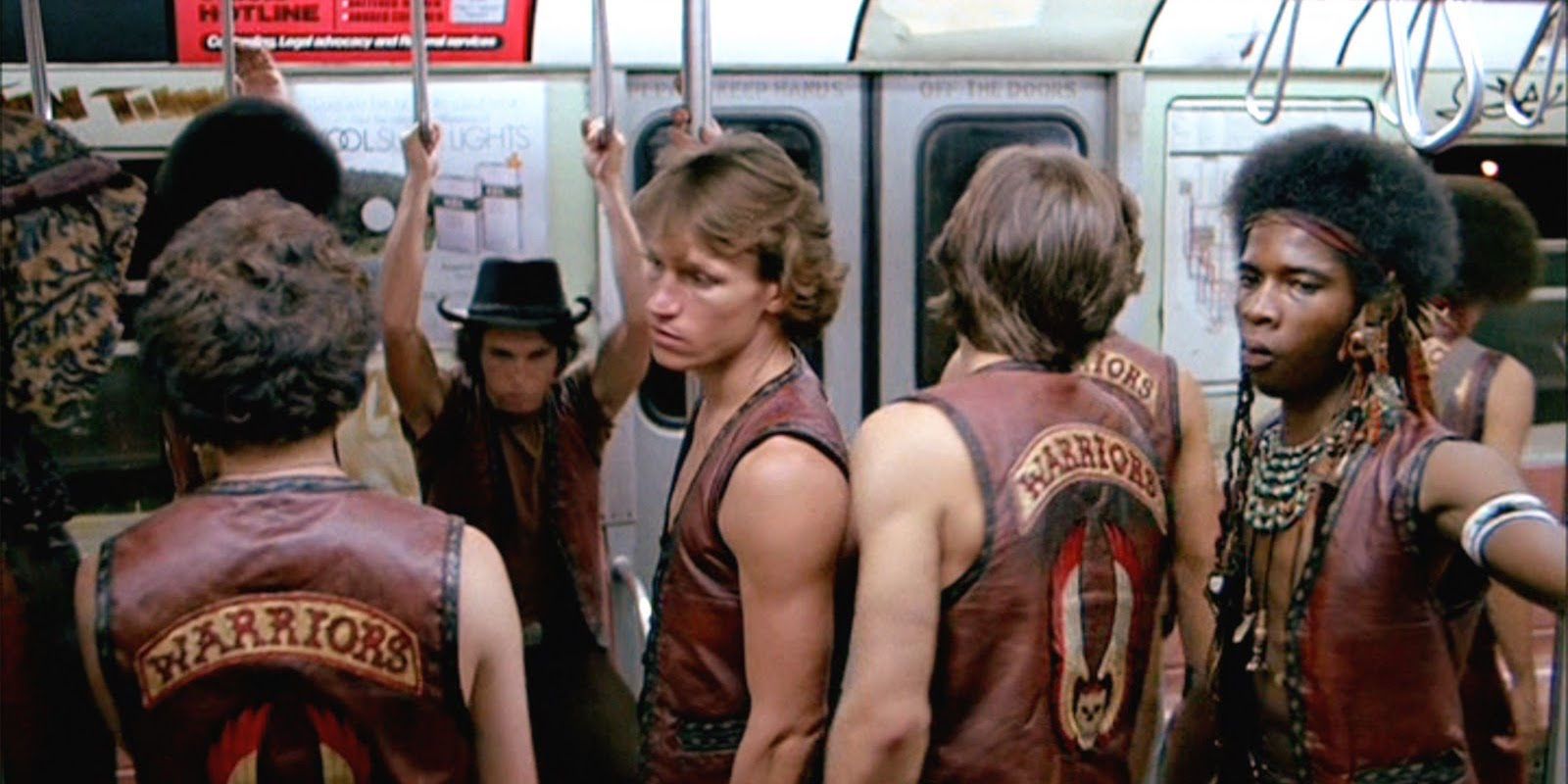 The Warriors hang on to rails on the train