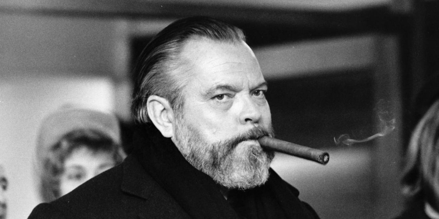Orson Welles smoking a cigar in a black and white picture