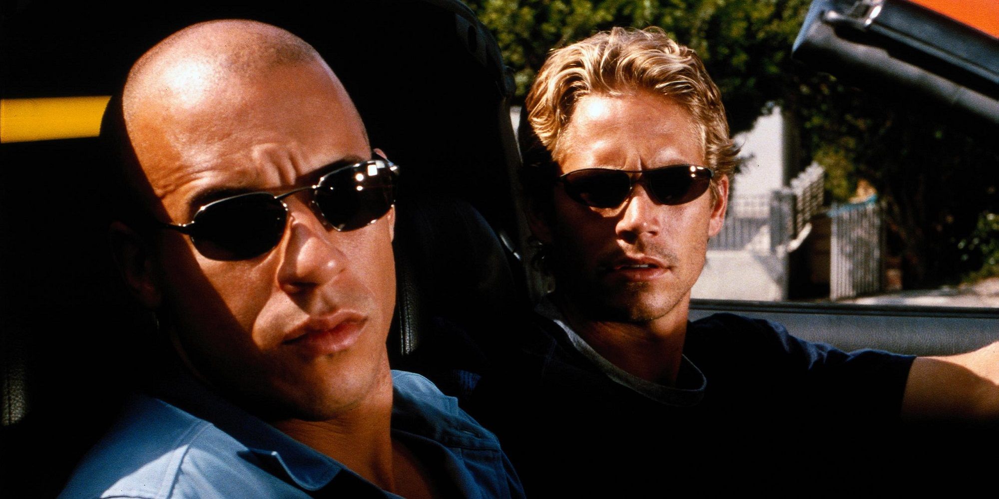 Dom and Brian wear shades and sit in a car