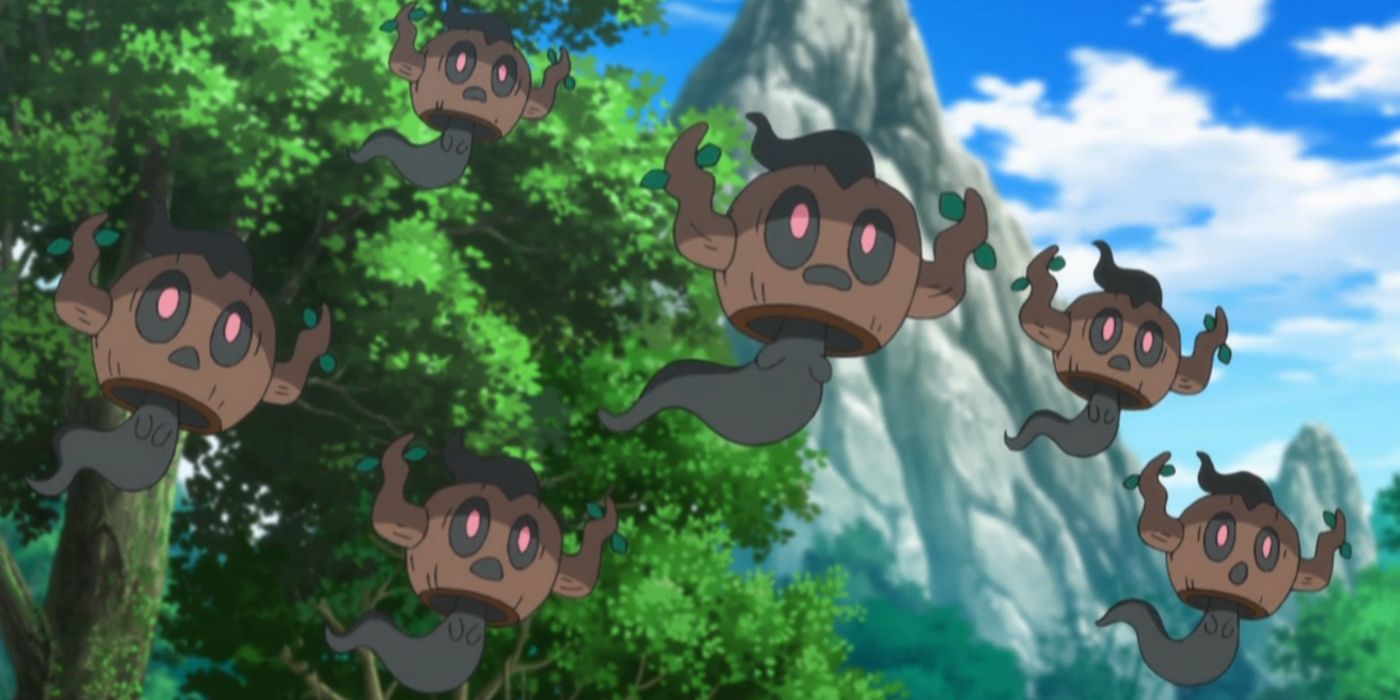 A group of Phantump floating in a forest in the Pokémon anime
