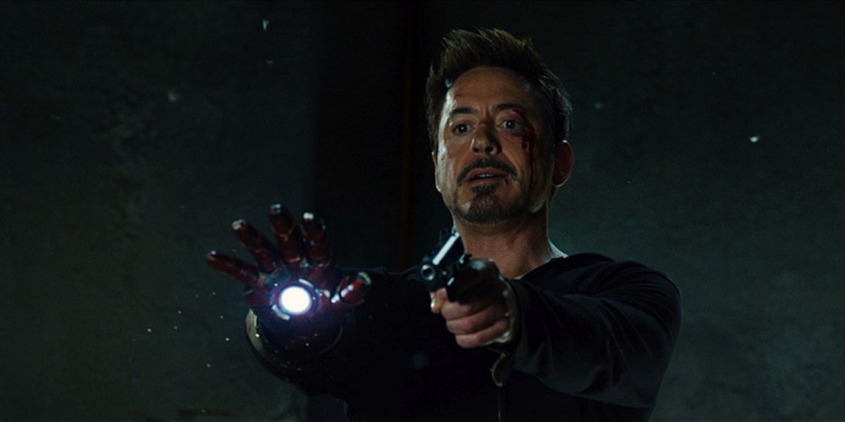 Tony aims his blaster and a gun in Iron Man 3