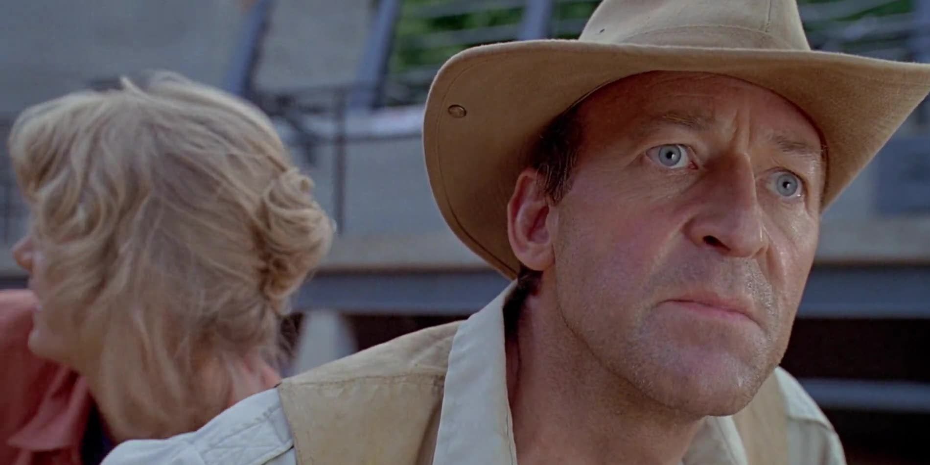 Robert Muldoon stays ahead of Ellie Sattler near the raptor enclosure in Jurassic Park