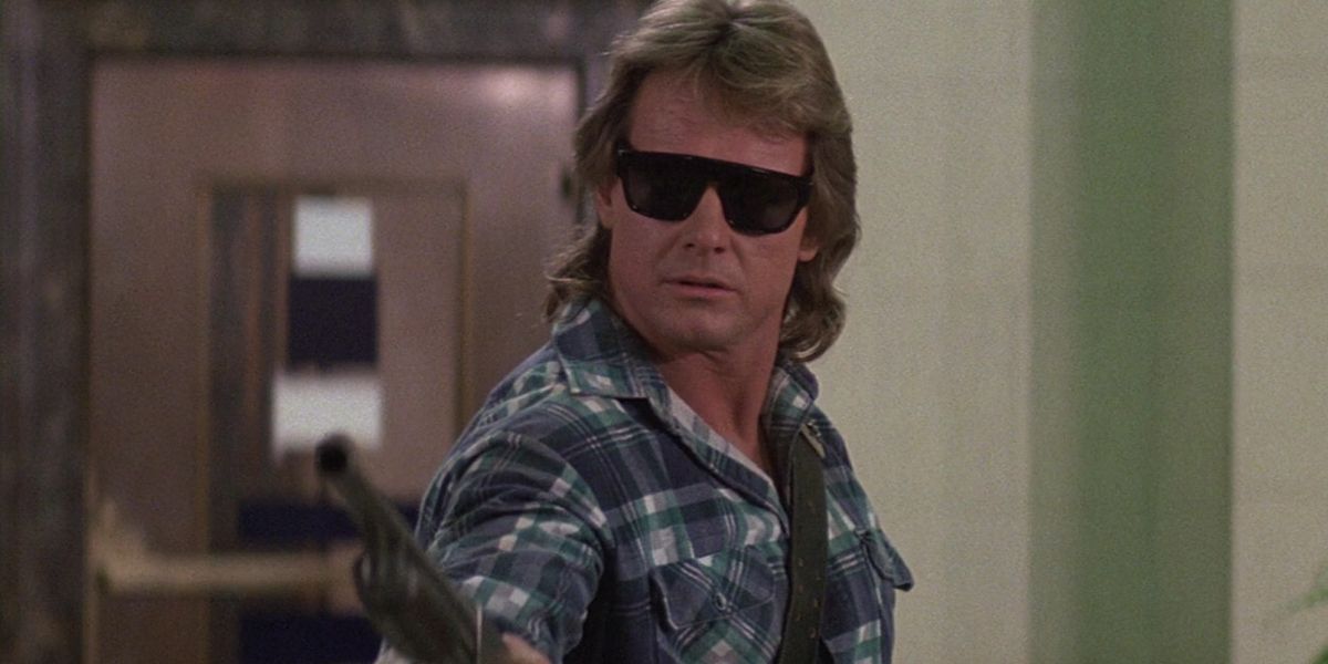 Roddy Piper points a shotgun in They Live
