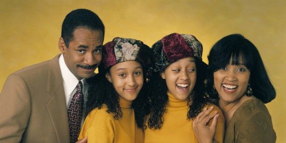 Tia and Tamara Mowry smile for the camera with their TV parents in a Sister, Sister promo image