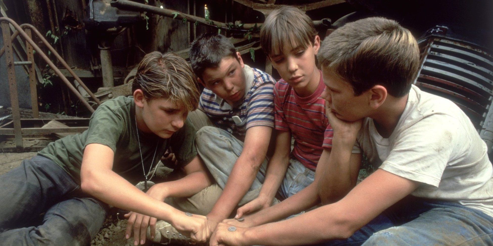 Four boys join hands in Stand By Me