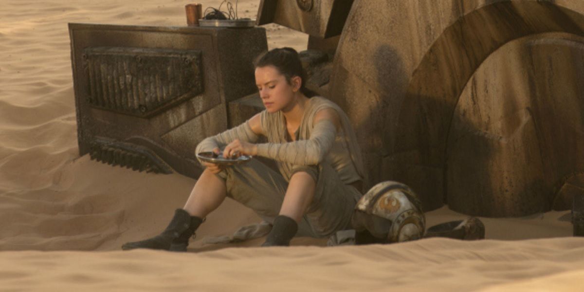 Rey eating her rations outside her abandoned AT-AT home on Jakku Hellhound two, in The Force Awakens
