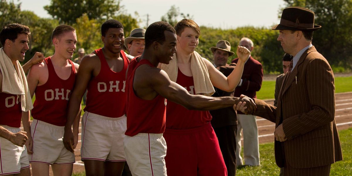 Coach Larry Snyder (Jason Sudeikis) shaking hands with Jesse Owens (Stephan James) in a still from Race 