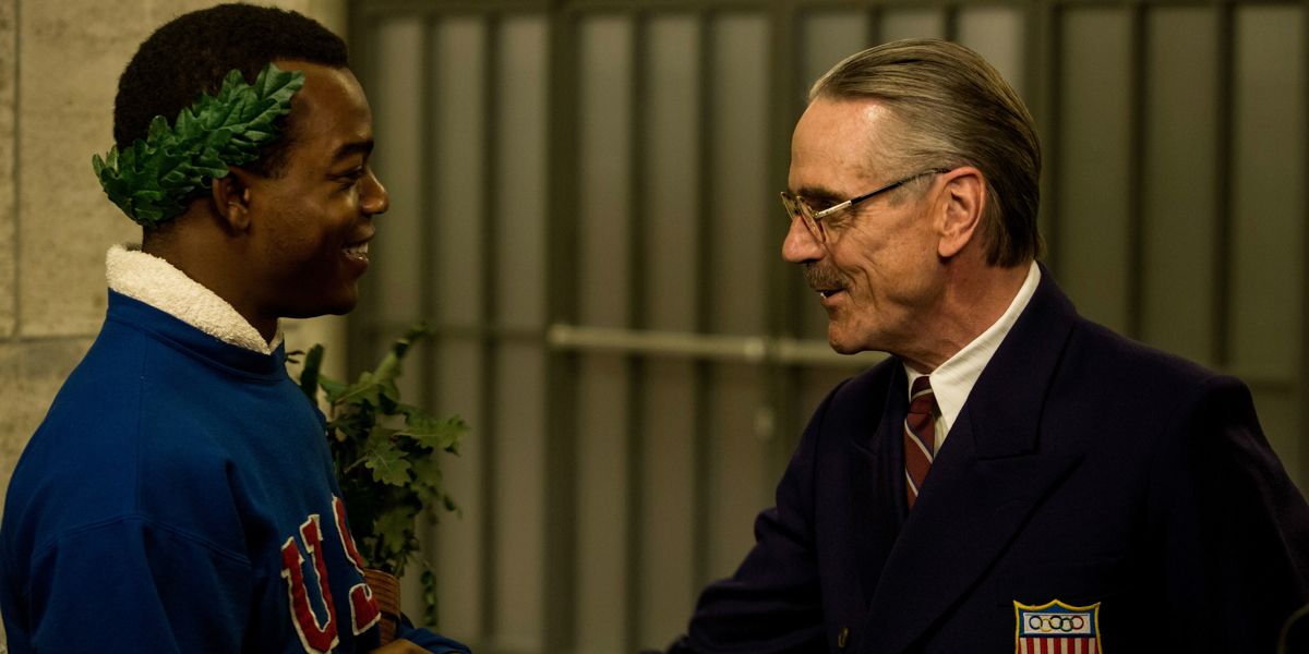 Stephan James and Jeremy Irons share a smile in Race