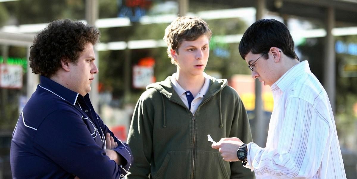Three teens look at a fake I.D. from Superbad 