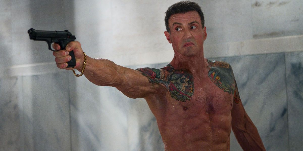 Sylvester Stallone shirtless and aiming a gun in Bullet to the Head