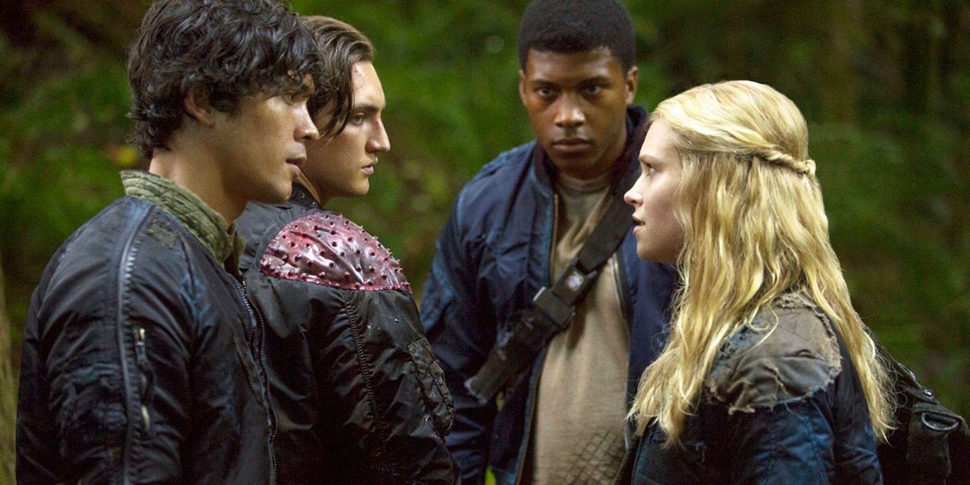 The 100 Cast members standing and looking at each other