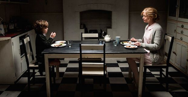 Noah Wiseman and Essie Davis in 'The Babadook' eating dinner across from each other