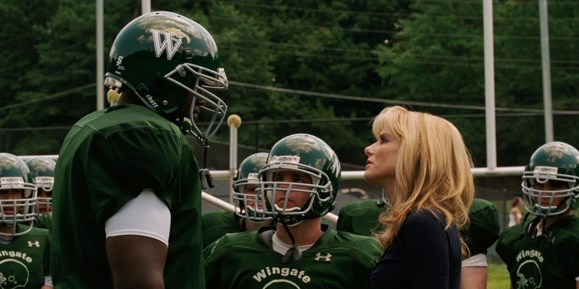 Leigh Ann and Michael talk on the field in The Blind Side