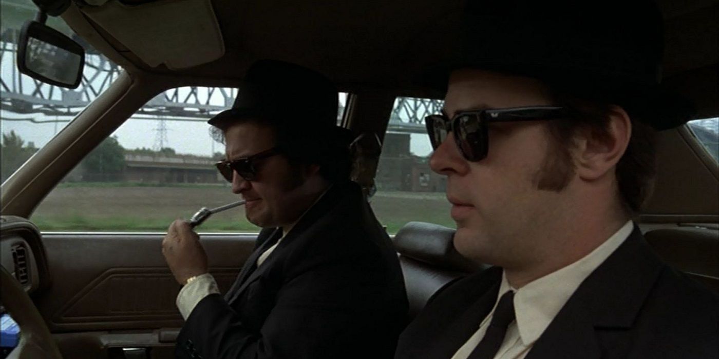 The Blues Brothers driving in their car.